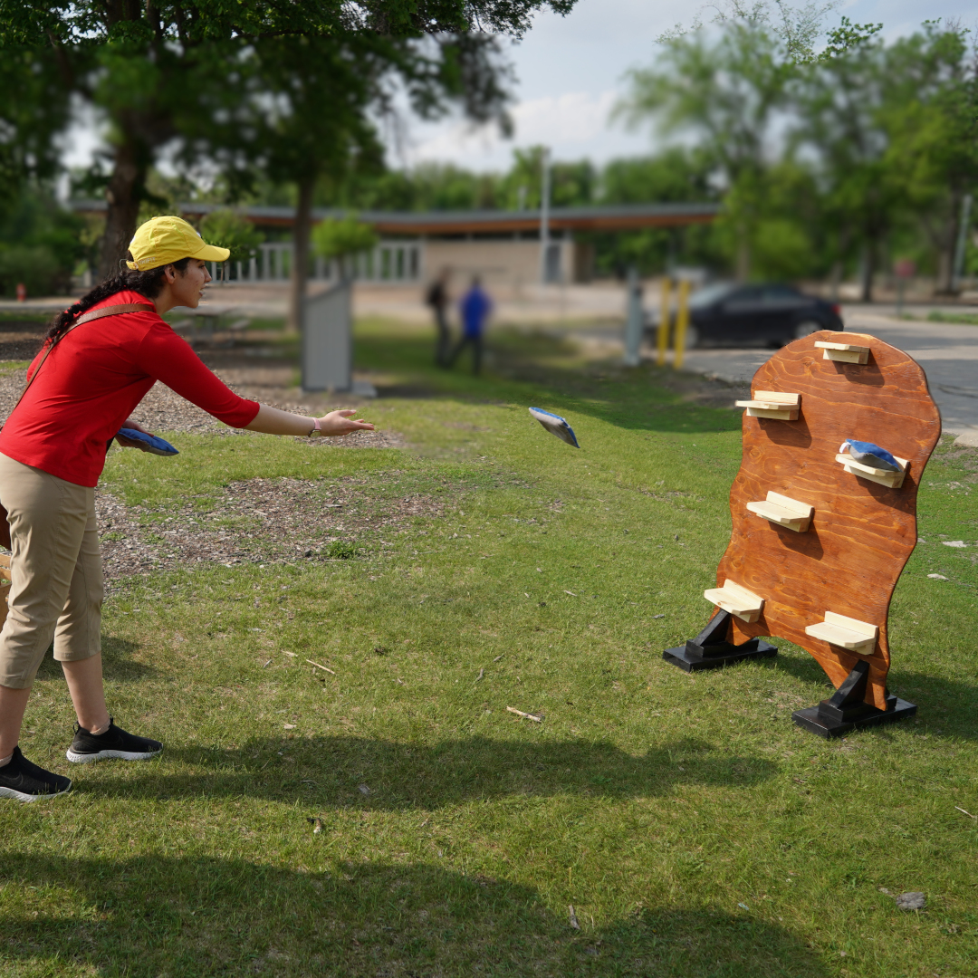 a person throwing a bean bag at the cliffhanger game