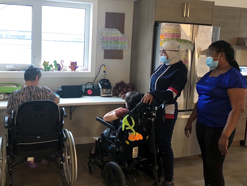 this photo shows people in wheelchairs meeting a potential roommate via an ipad