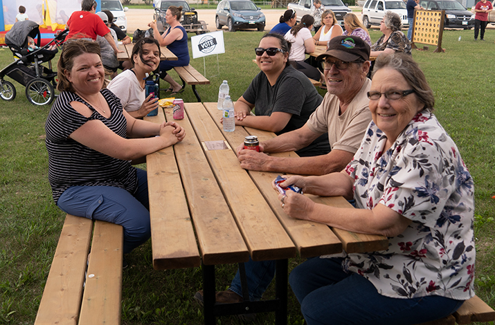 people sit on a picnic bench