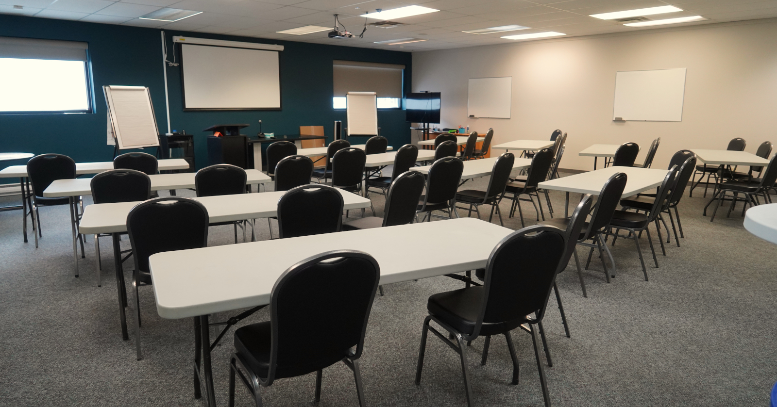picture of classroom set up with tables in rows