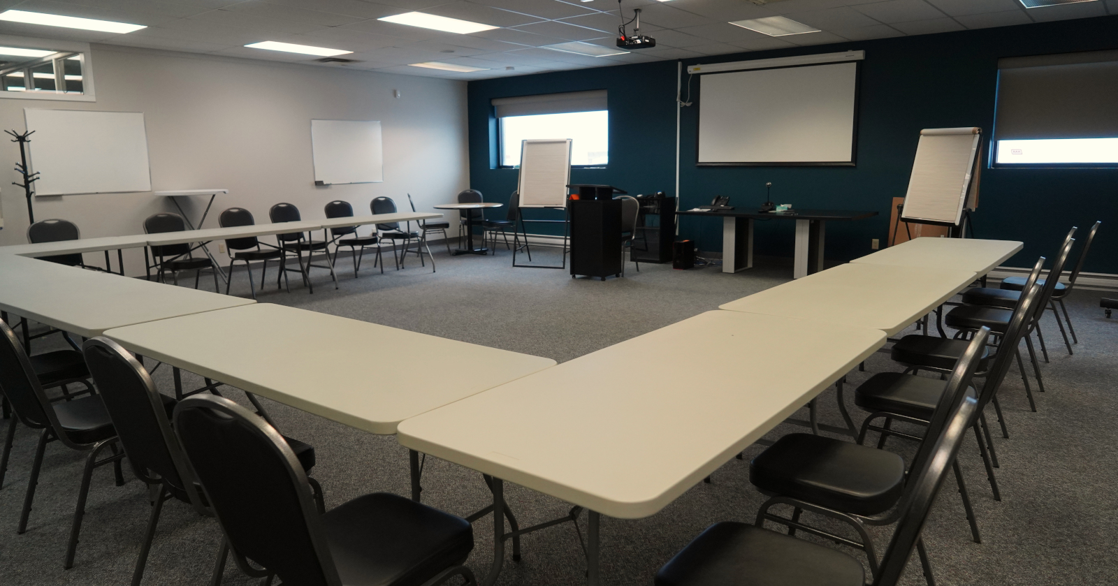 Tables are set in a continuous u-shape with chairs on the outside